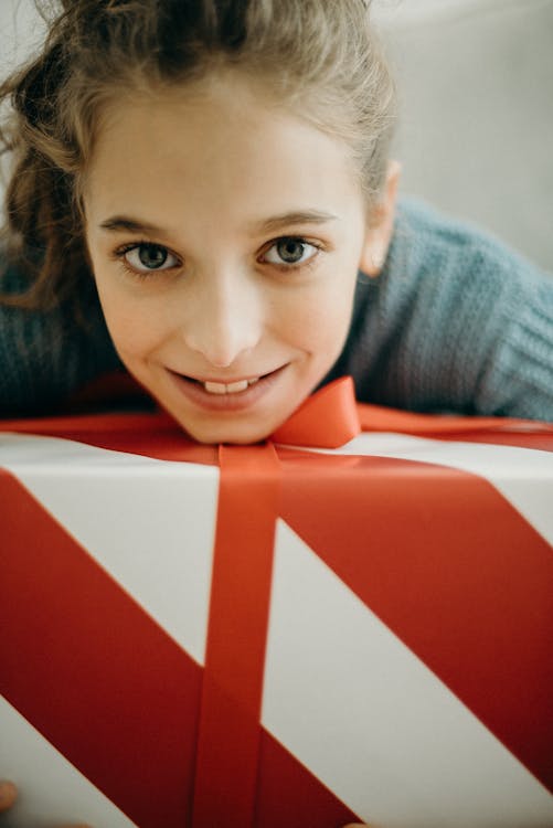 Free Girl With A Red and White Striped Gift Box Stock Photo