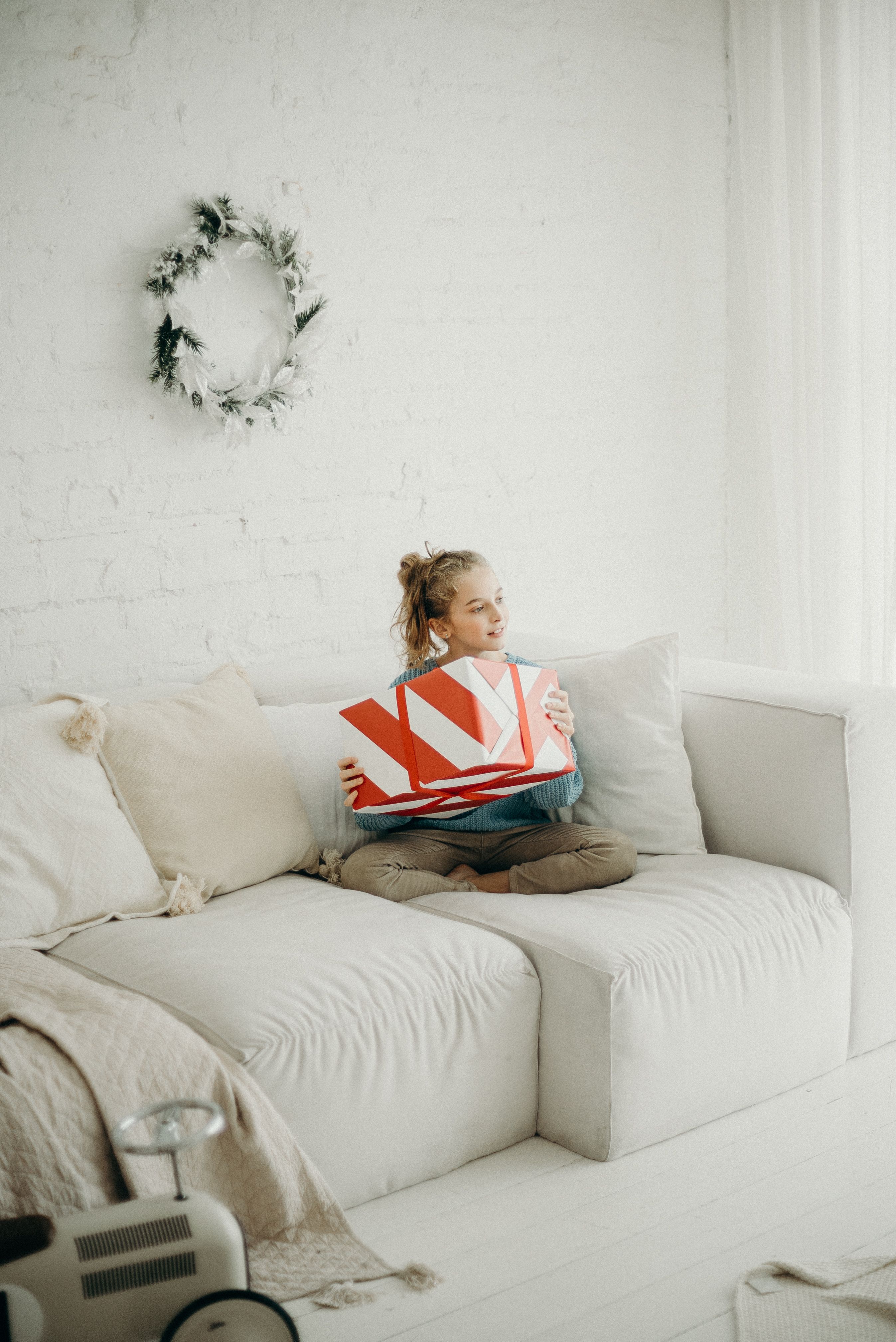 Photo of Girl Sitting on White Sofa with Her Legs Crossed ...