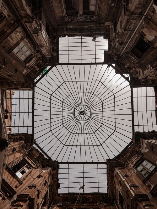 Free Upward view of an intricately designed architectural ceiling with symmetric lines. Stock Photo