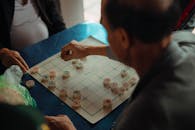 Adults playing Xiangqi game in Hanoi Vietnam