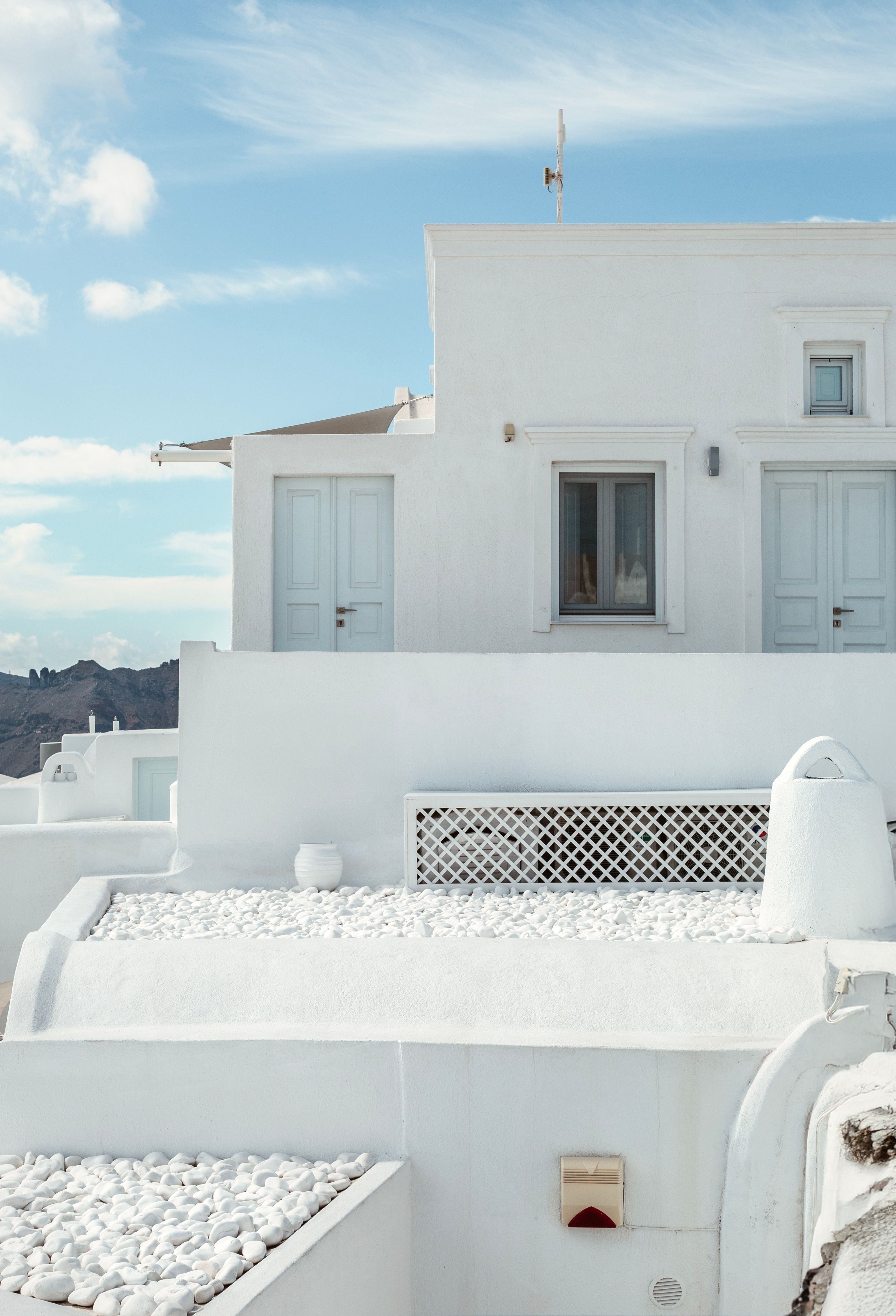 Beautiful whitewashed architecture in Fira, Santorini with clear blue skies.