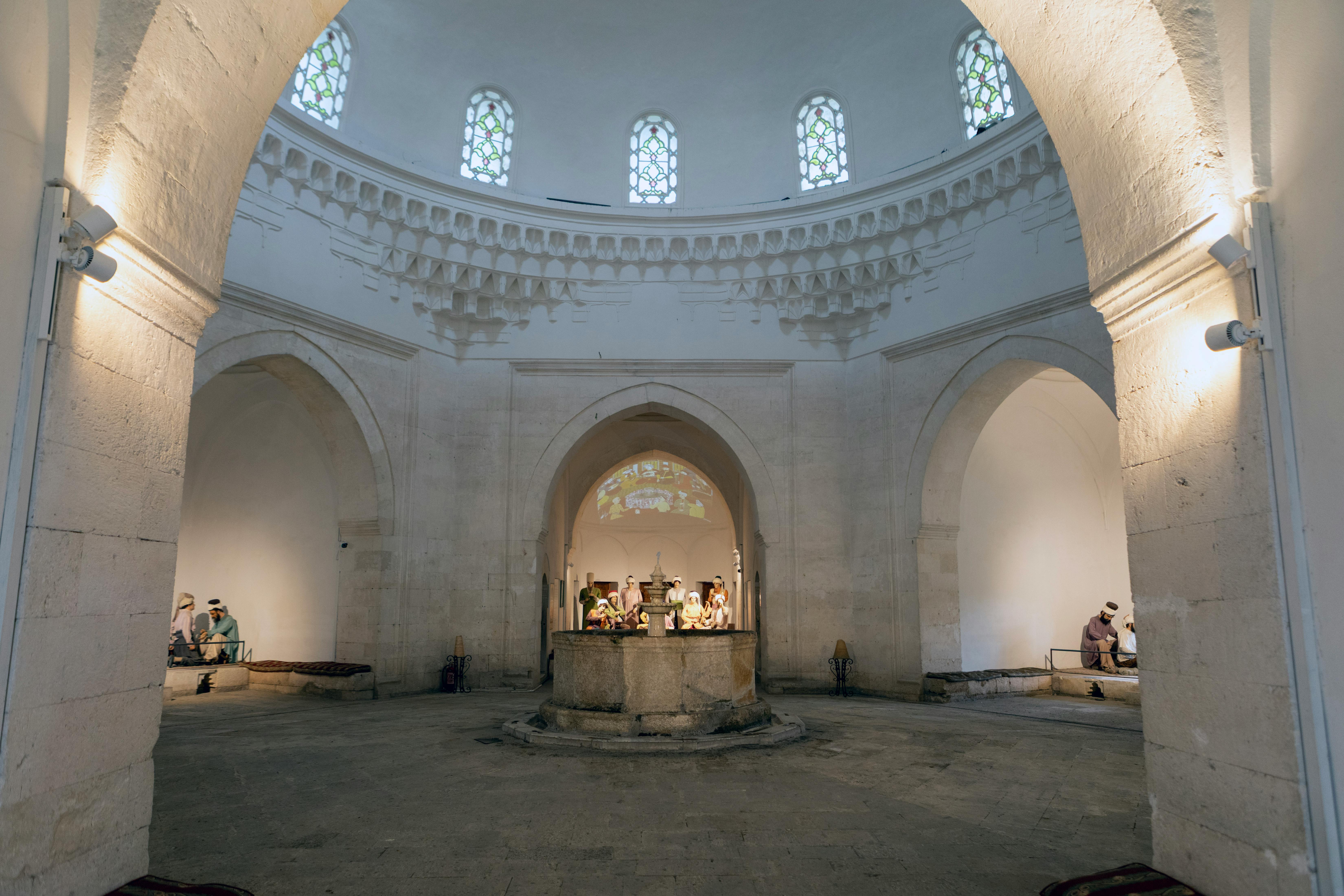 Interior of a historical Ottoman bathhouse with a domed ceiling, showcasing intricate architecture and cultural heritage.