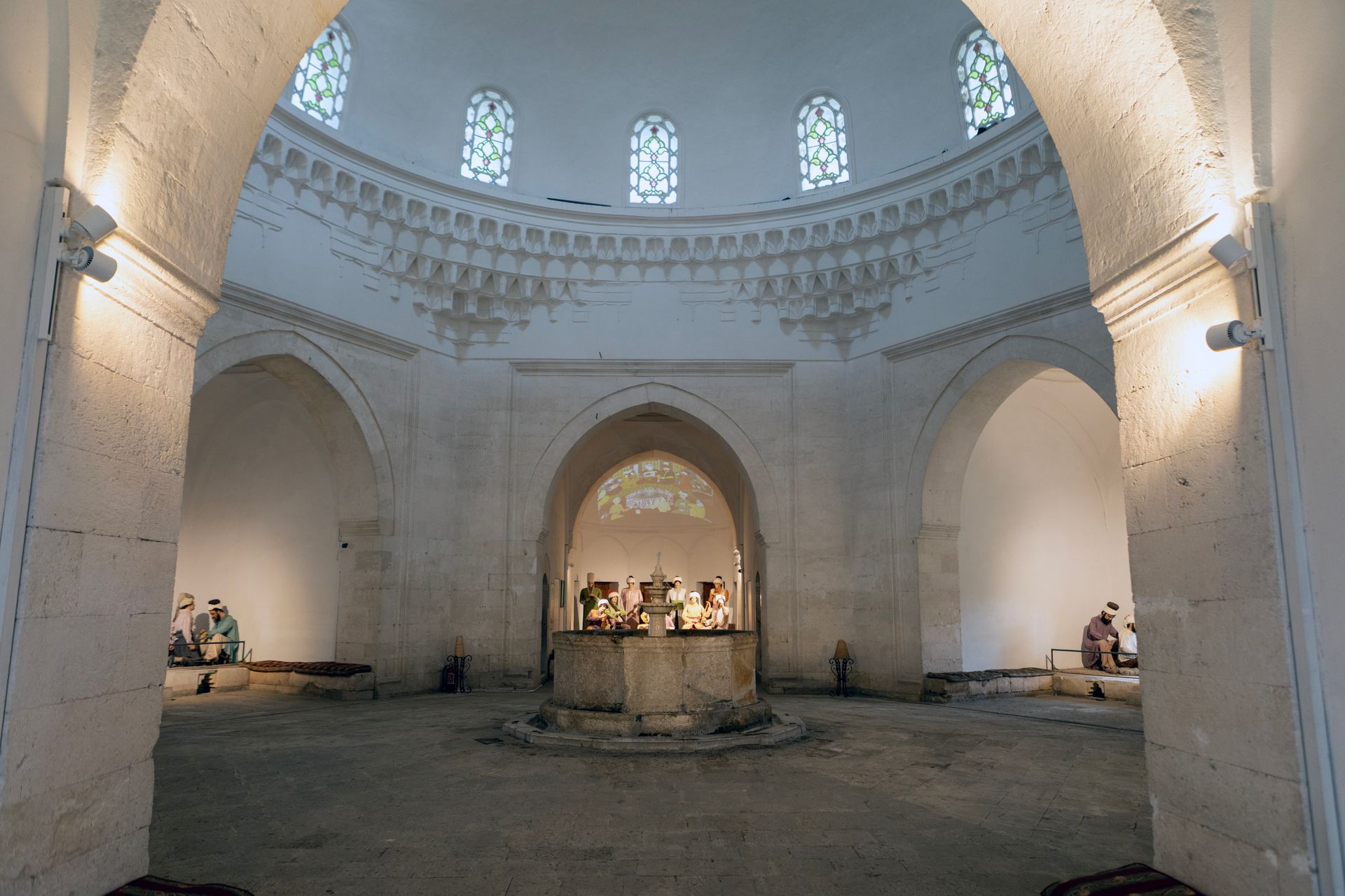 Interior of a historical Ottoman bathhouse with a domed ceiling, showcasing intricate architecture and cultural heritage.