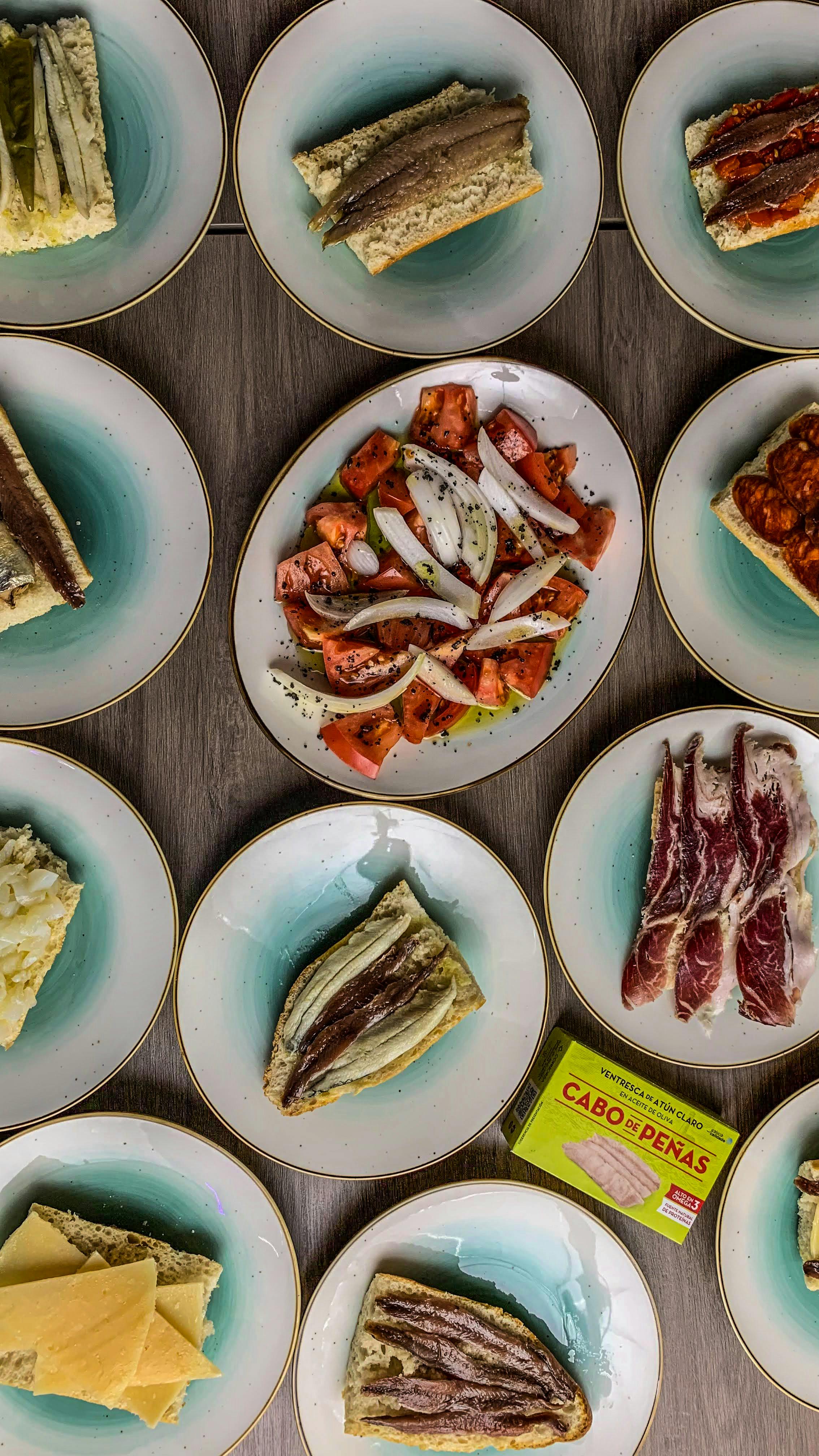 A platter of colorful Spanish tapas dishes arranged on a table.