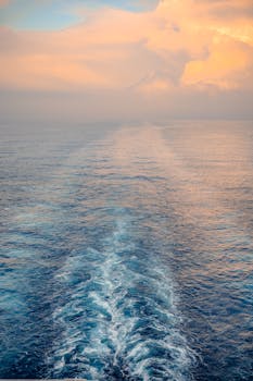 Capture the serene beauty of ocean waves under a warm, glowing sunrise. Perfect for calming visuals.