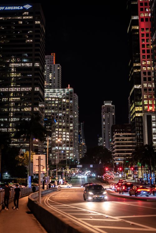Free A lively nighttime scene in downtown Miami with illuminated skyscrapers and bustling traffic. Stock Photo