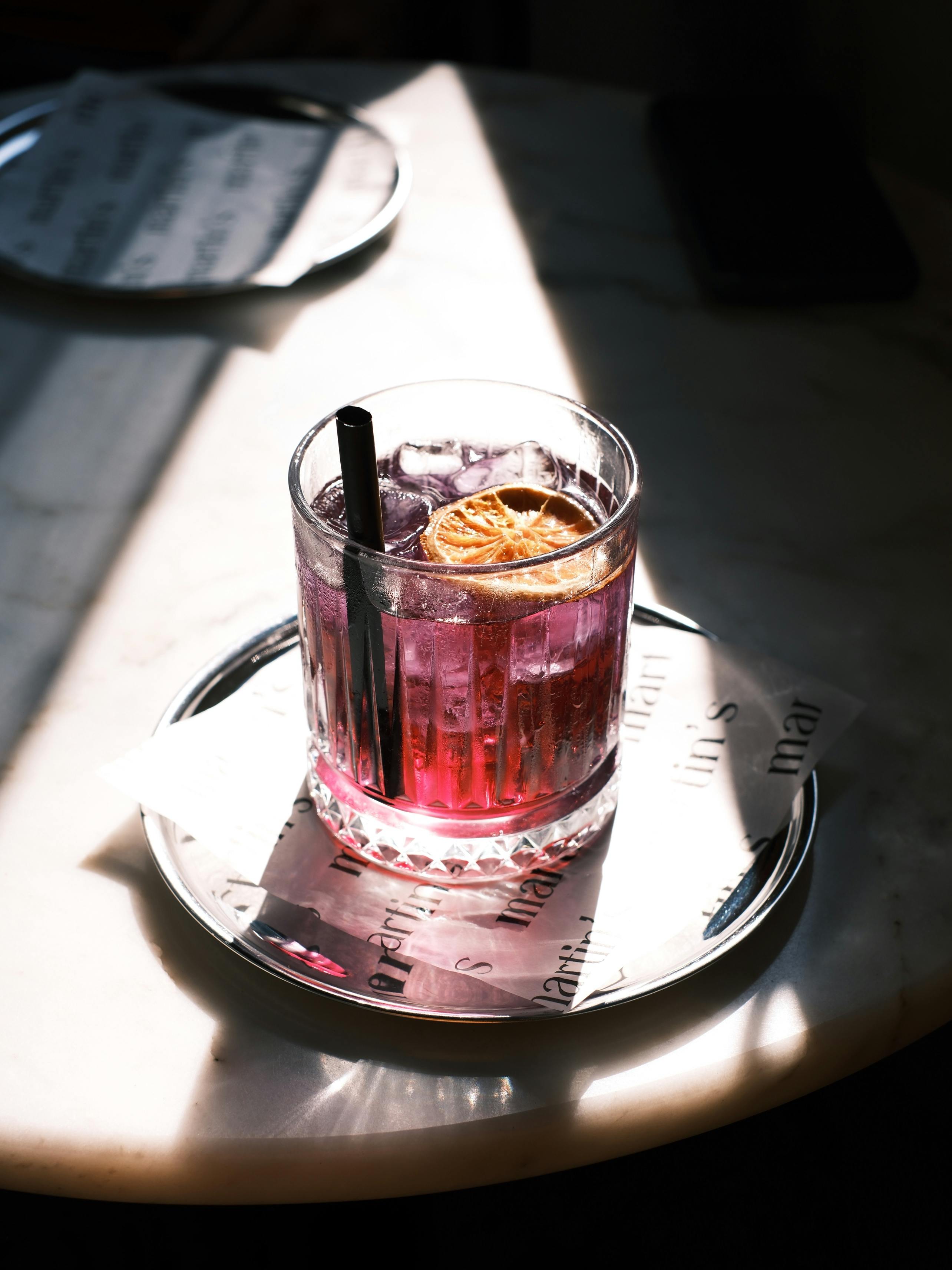 A colorful cocktail with a citrus garnish, perfect for social gatherings.