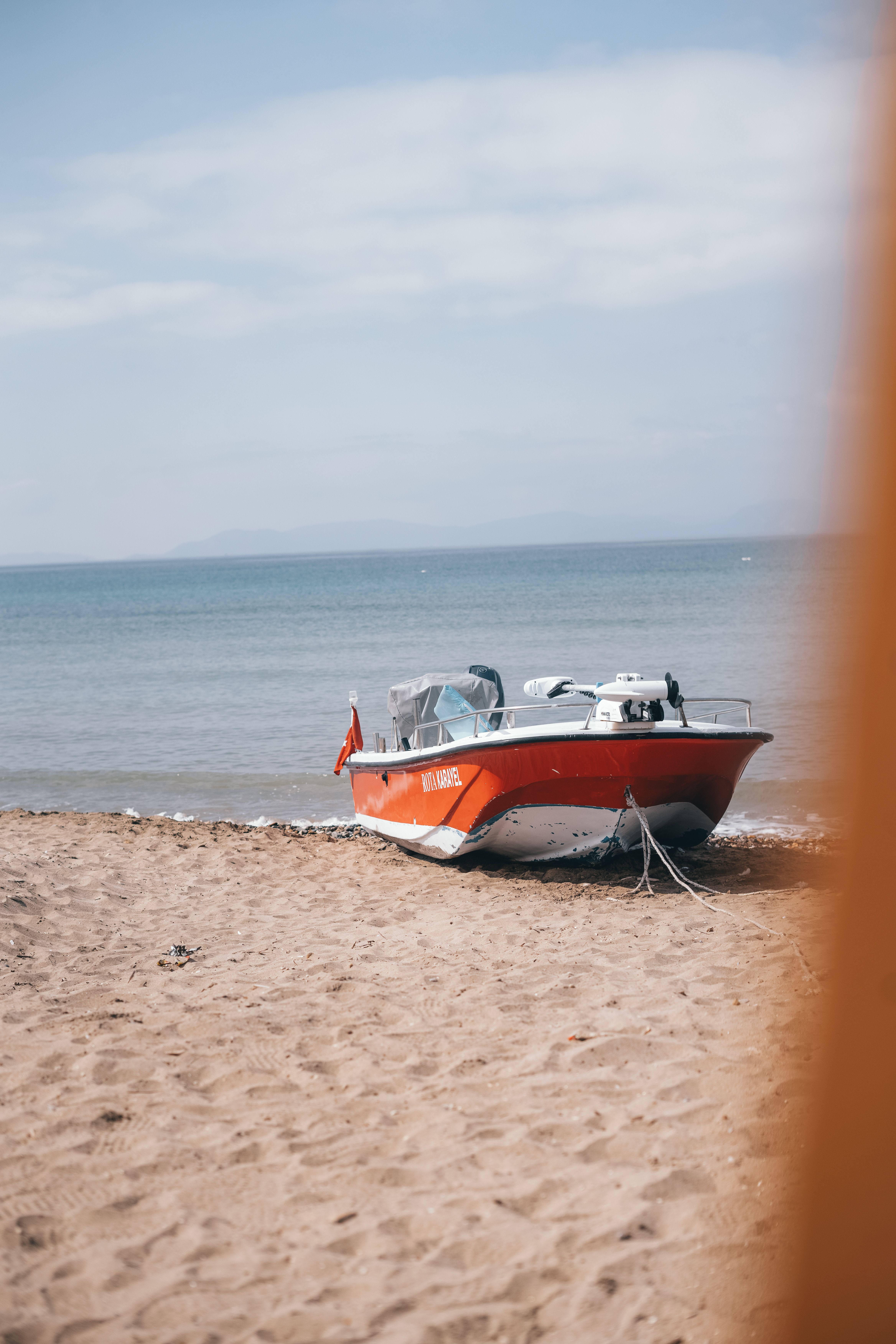 Red Boat on Sandy Beach by the Sea · Free Stock Photo
