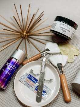 A variety of skincare and beauty tools arranged artistically on a textured surface.