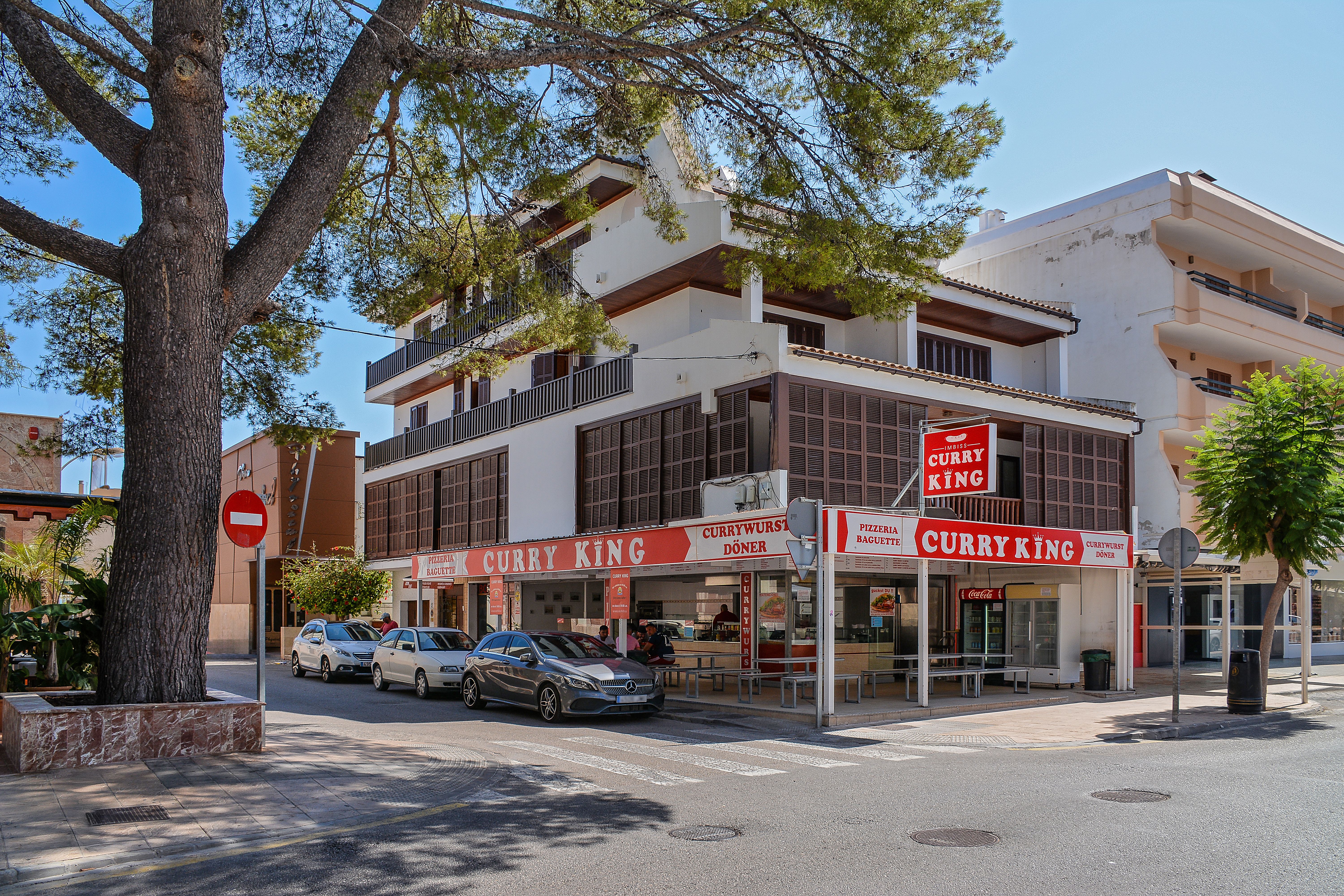 Street view of Curry King restaurant in sunny Cala Rajada, Spain.
