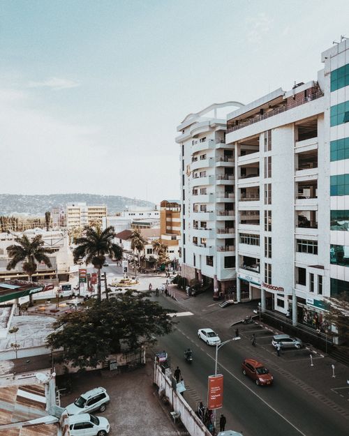 Free A bustling urban scene featuring modern buildings and a busy street during the day. Stock Photo