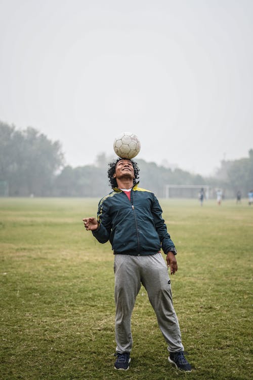 Free Man Doing Tricks with Soccer Ball Stock Photo