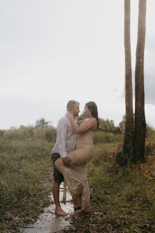 Free Tender moment of a couple embracing in the rain, outdoors in nature. Stock Photo