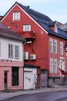 Picturesque wooden houses in Tromsø, Norway. Capture the essence of Nordic architecture in a winter setting.