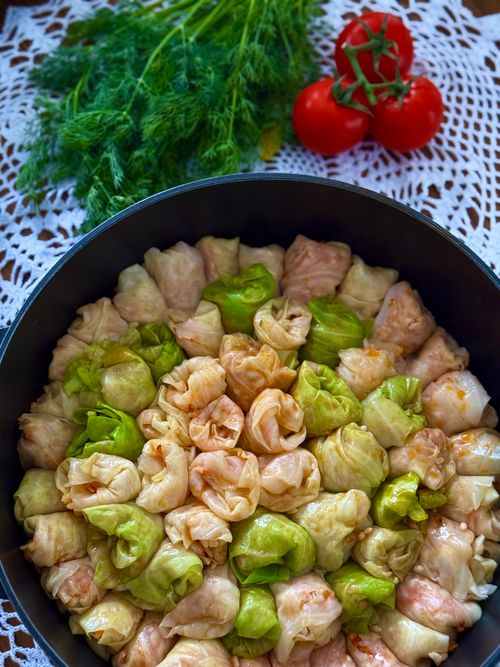 Free Freshly prepared stuffed cabbage rolls with dill and tomatoes garnish. Stock Photo