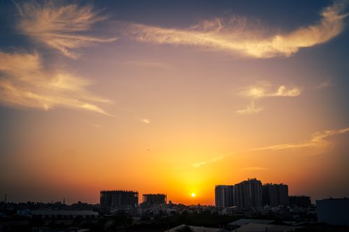 Free Beautiful sunset with dramatic clouds over Karachi's skyline, blending urban architecture with nature. Stock Photo