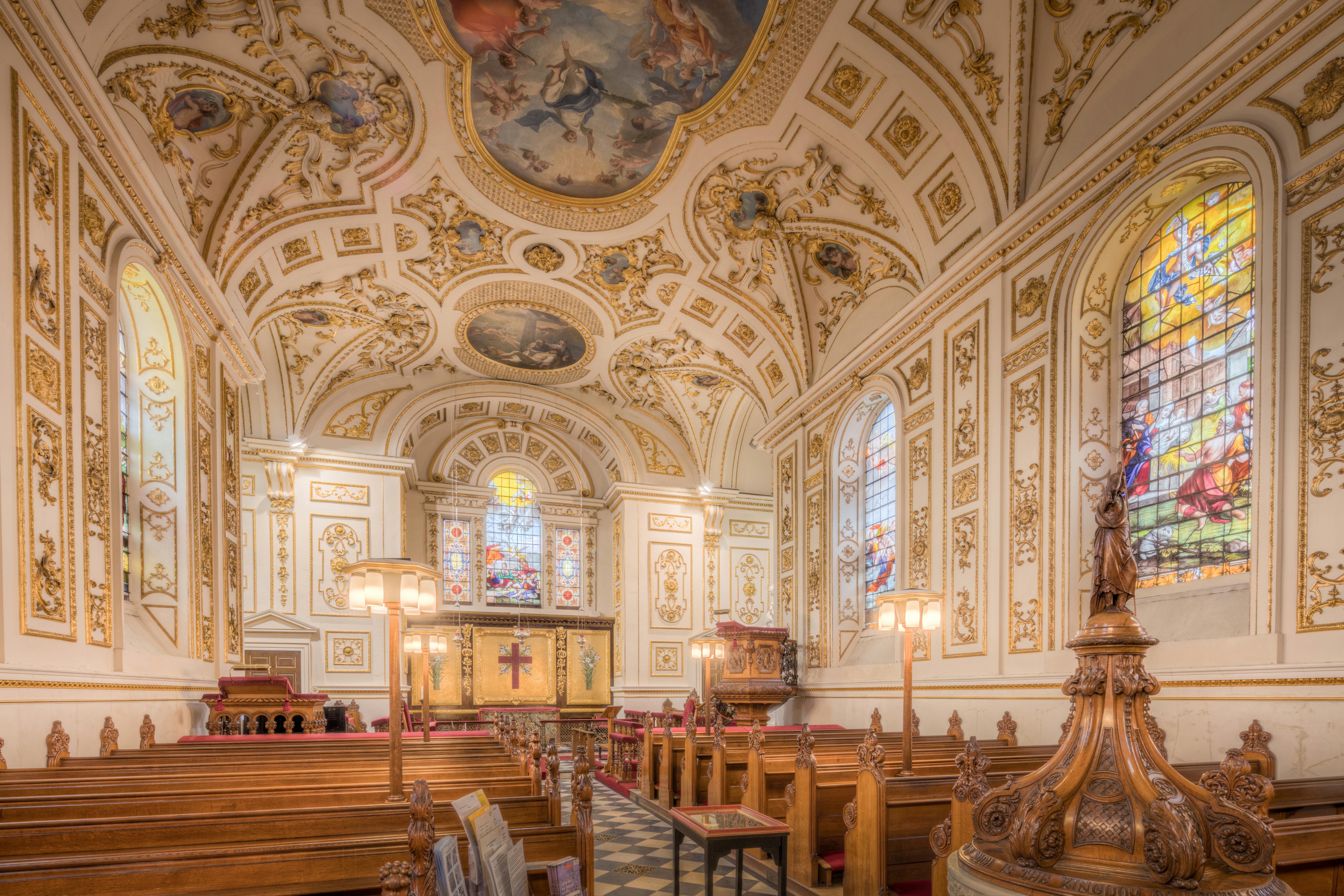 Stunning baroque interior of Great Witley Church with ornate decorations and stained glass windows.