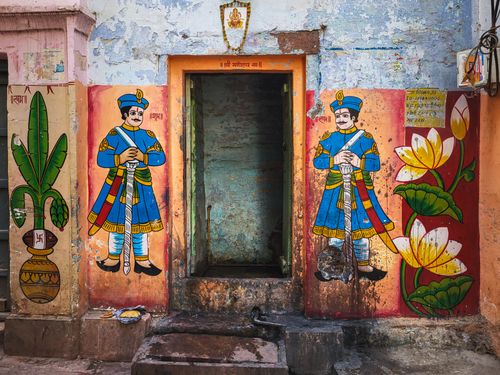Free Vibrant street art and murals adorn a doorway in historic Varanasi, India. Stock Photo