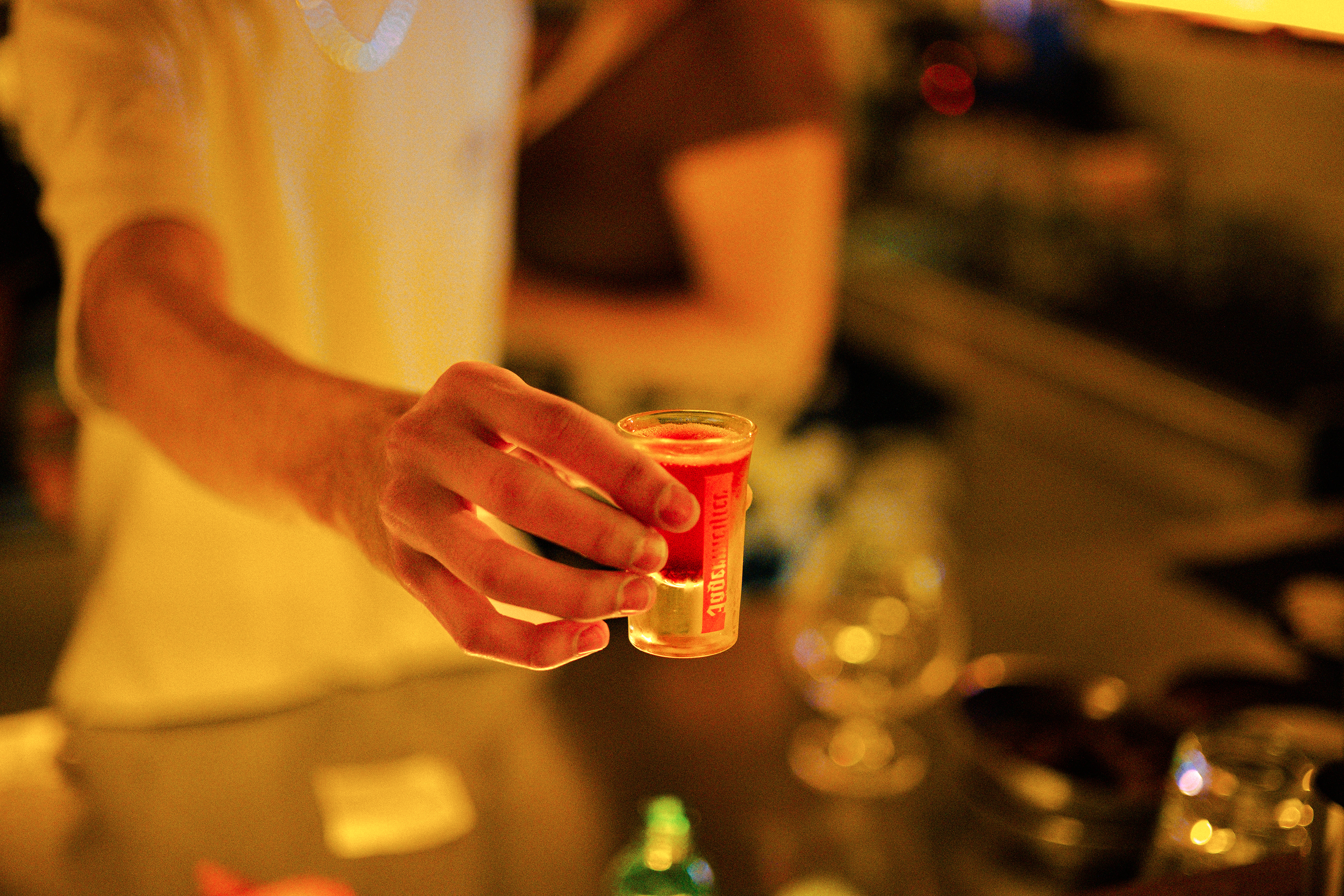 Close-Up of Hand Holding a Colorful Cocktail Shot · Free Stock Photo