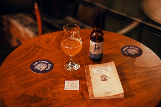 Warm pub atmosphere featuring a beer bottle and glass on a wooden table, perfect for relaxation.