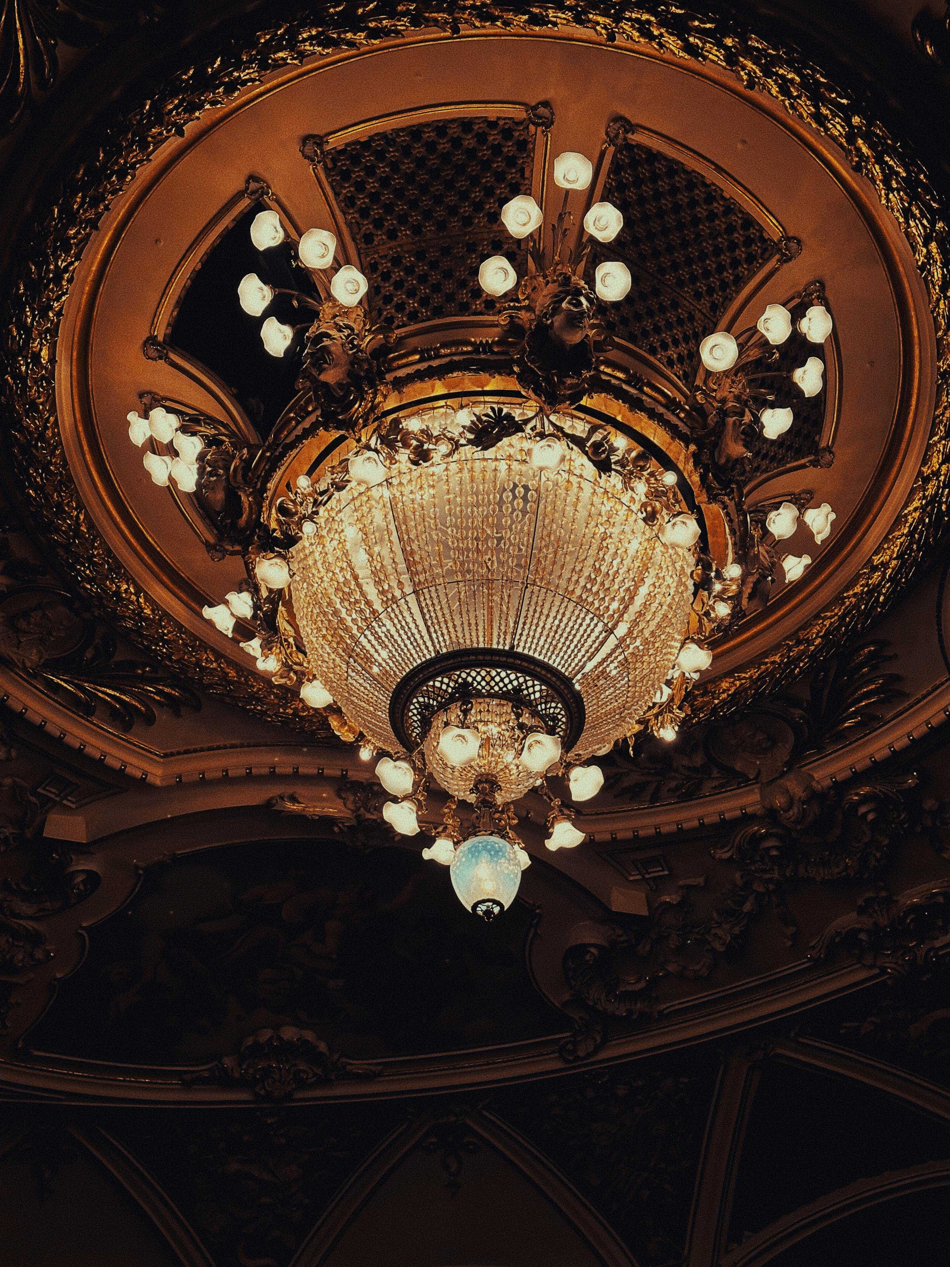 Free Stunning chandelier in a historic theater, showcasing intricate ceiling art and warm lighting. Stock Photo