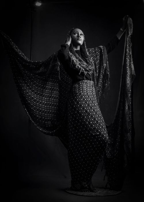 Free Black and white portrait of woman in traditional attire with a dramatic pose. Stock Photo