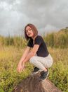 Photo Of Woman Sitting On Top Of Rock