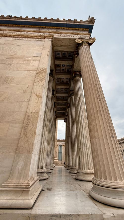 Free Stunning perspective view of neo-classical marble columns against a cloudy sky. Stock Photo