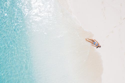 Woman Lying on Seashore