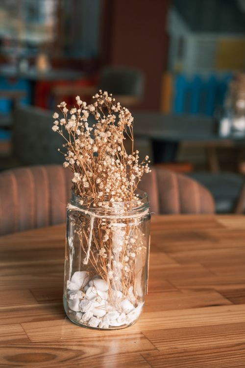 Free Aesthetic display of dried flowers in a glass jar on a wooden table, perfect for decor inspiration. Stock Photo