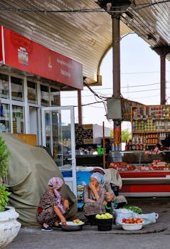 Local vendors selling fresh produce at a bustling outdoor market.