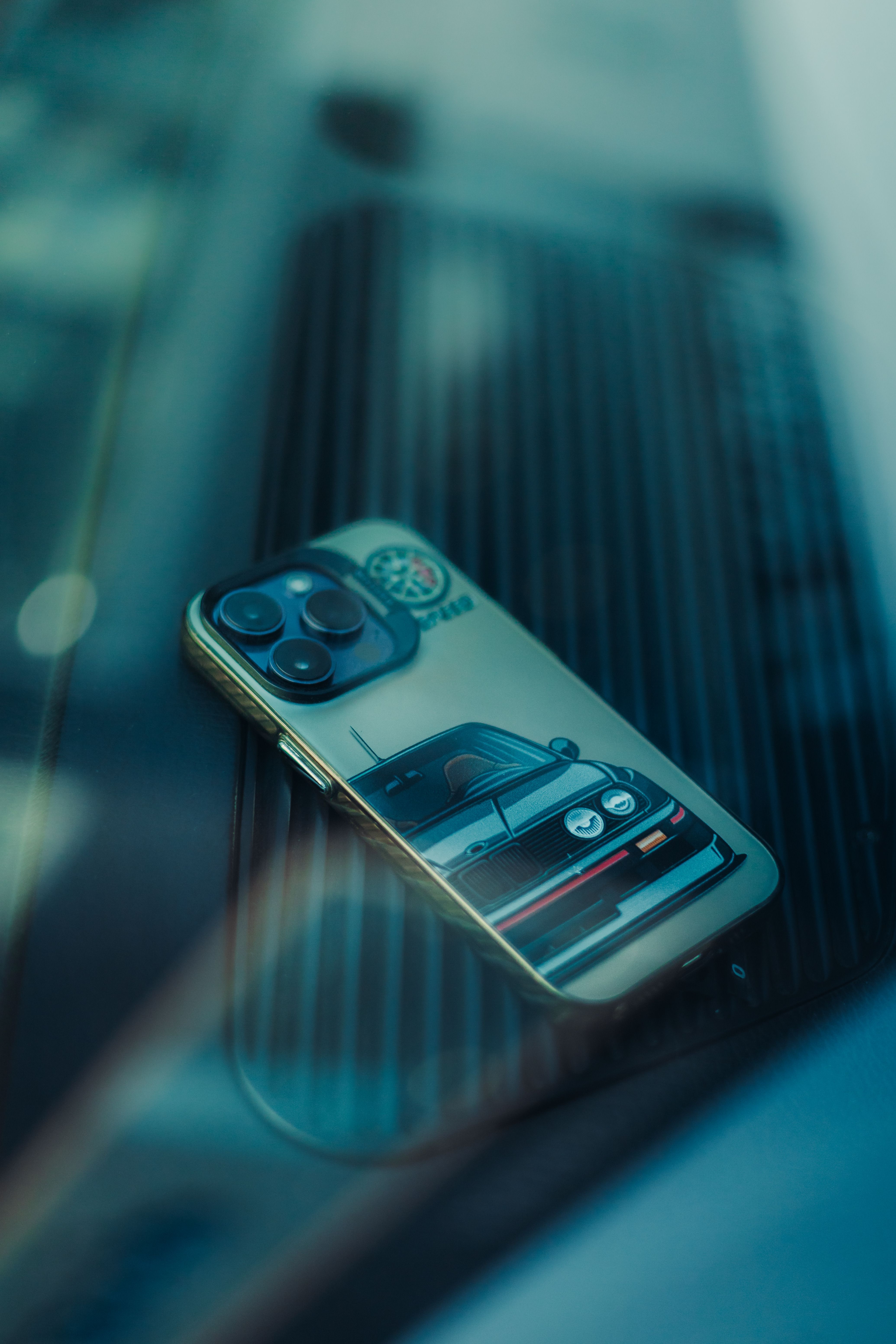 Smartphone with Car-themed Case on Glass Surface · Free Stock Photo