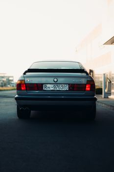 Rear view of a classic car parked outdoors, showcasing vintage design.