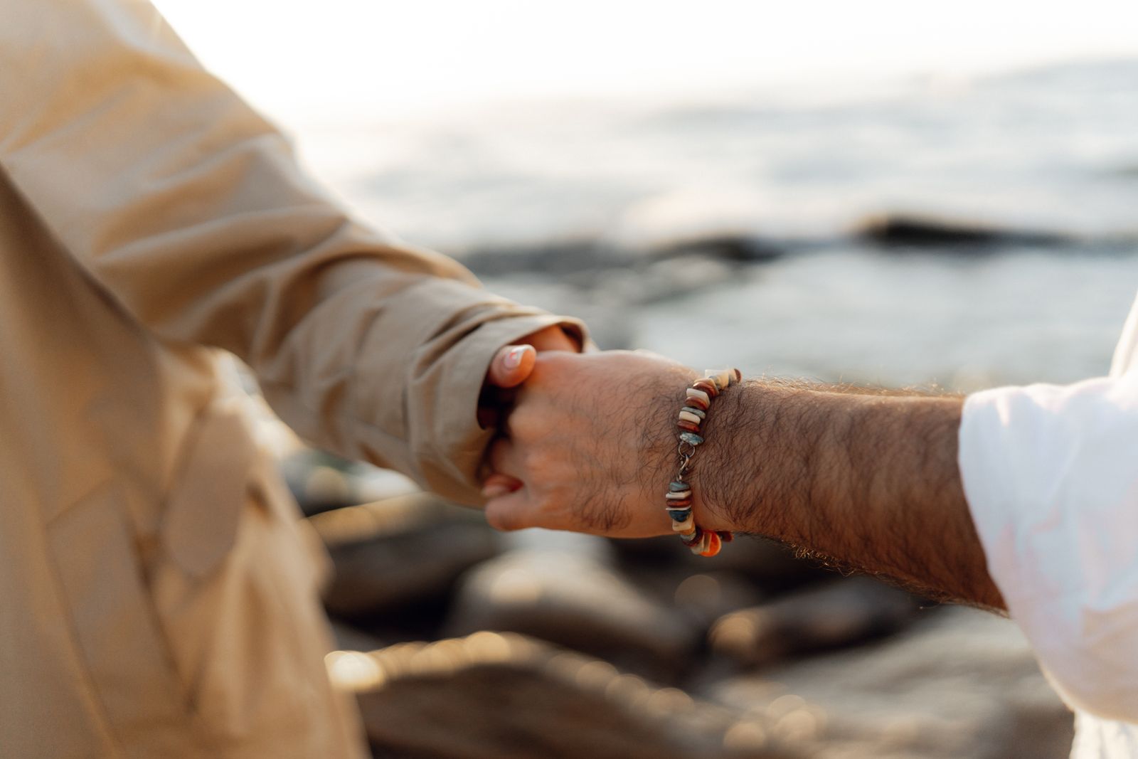 Clinician checking a person's wrist and thumb during a hand support consultation