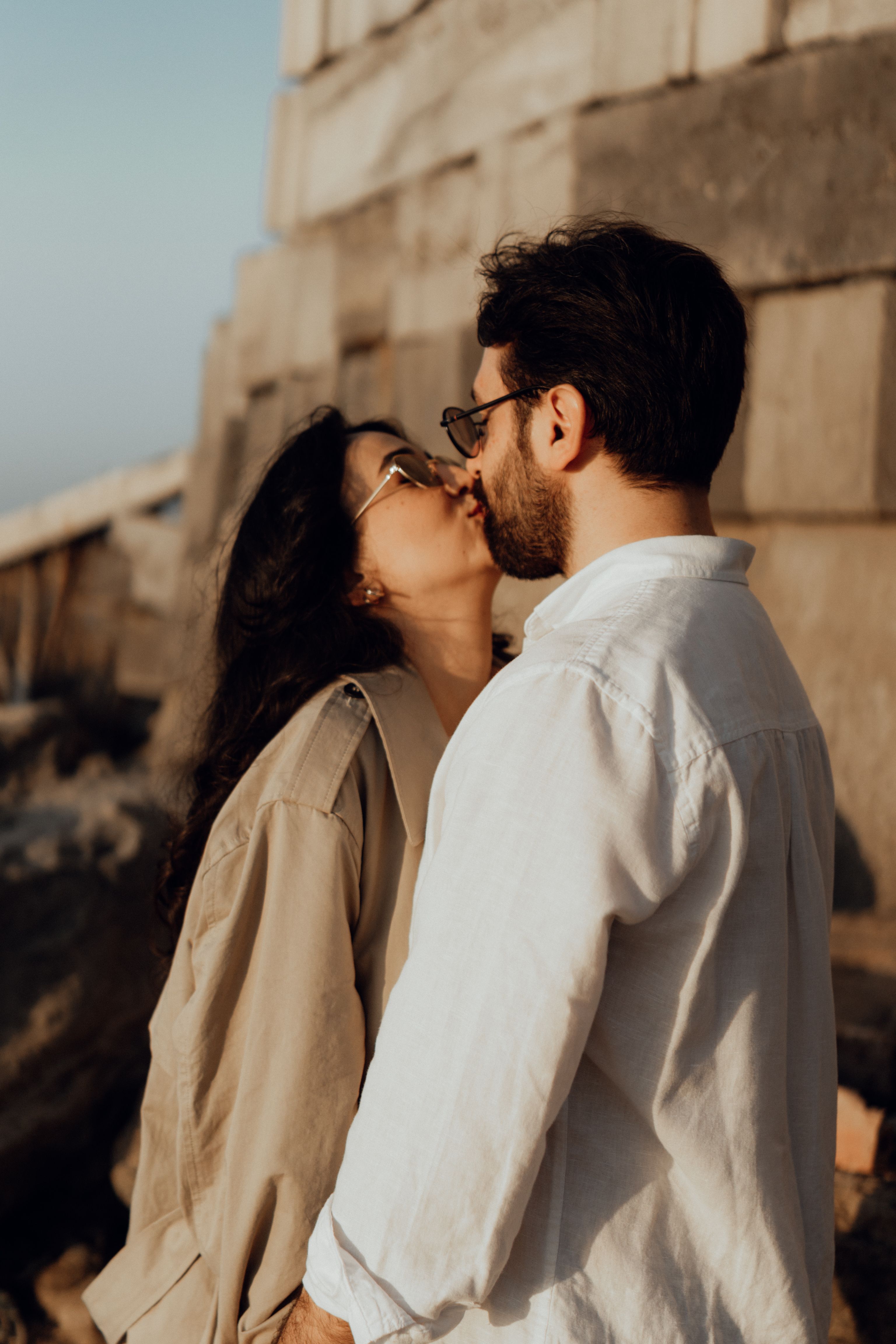 Romantic Couple Sharing a Tender Kiss Outdoors · Free Stock Photo