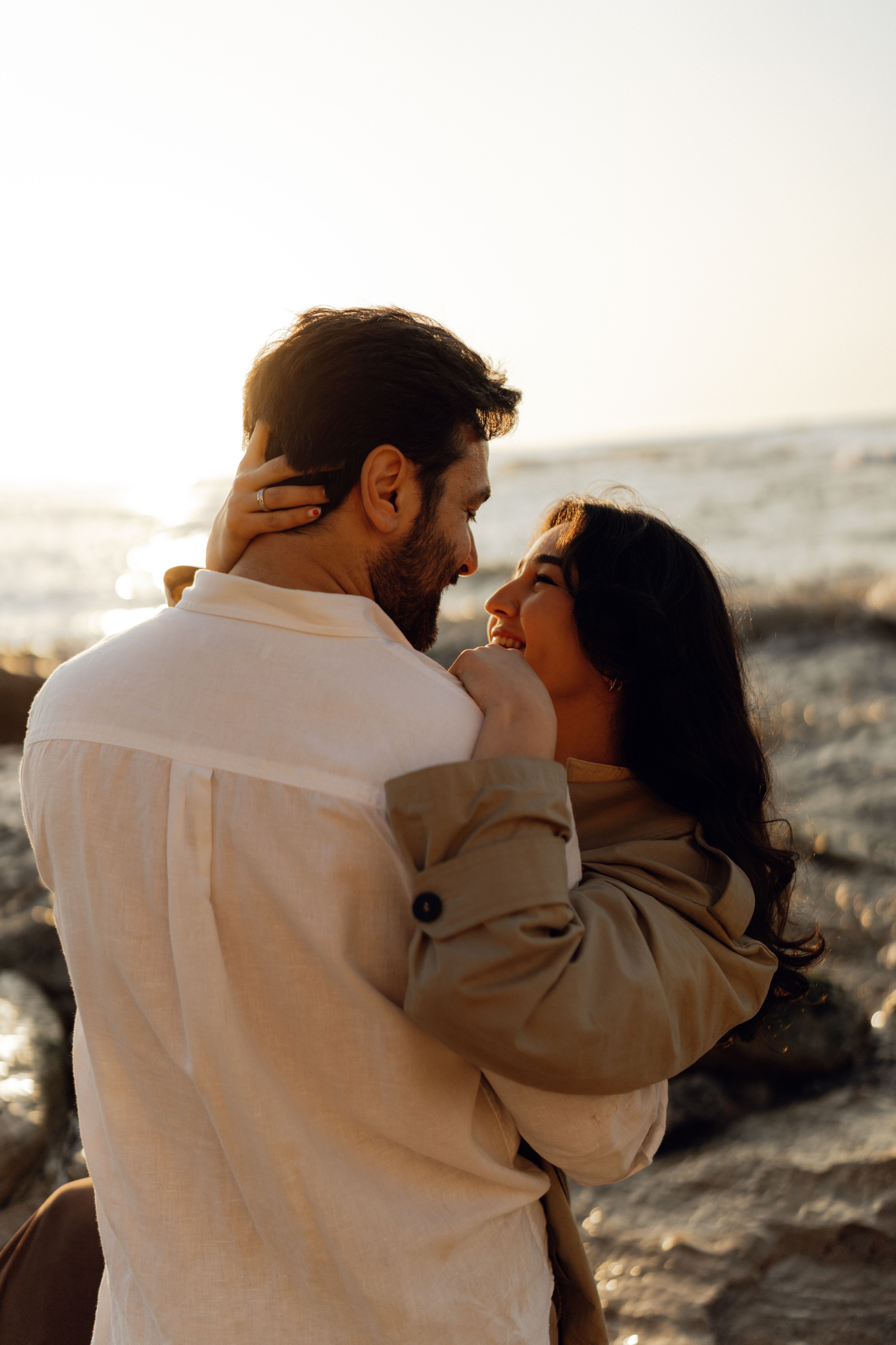 Romantic Couple Embracing at Sunset on Beach · Free Stock Photo