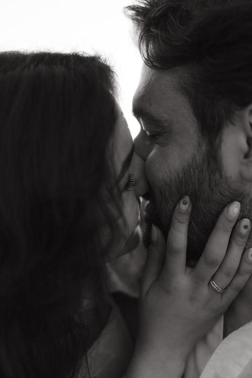 Free A black and white close-up photo of a couple sharing an intimate moment, capturing love and tenderness. Stock Photo