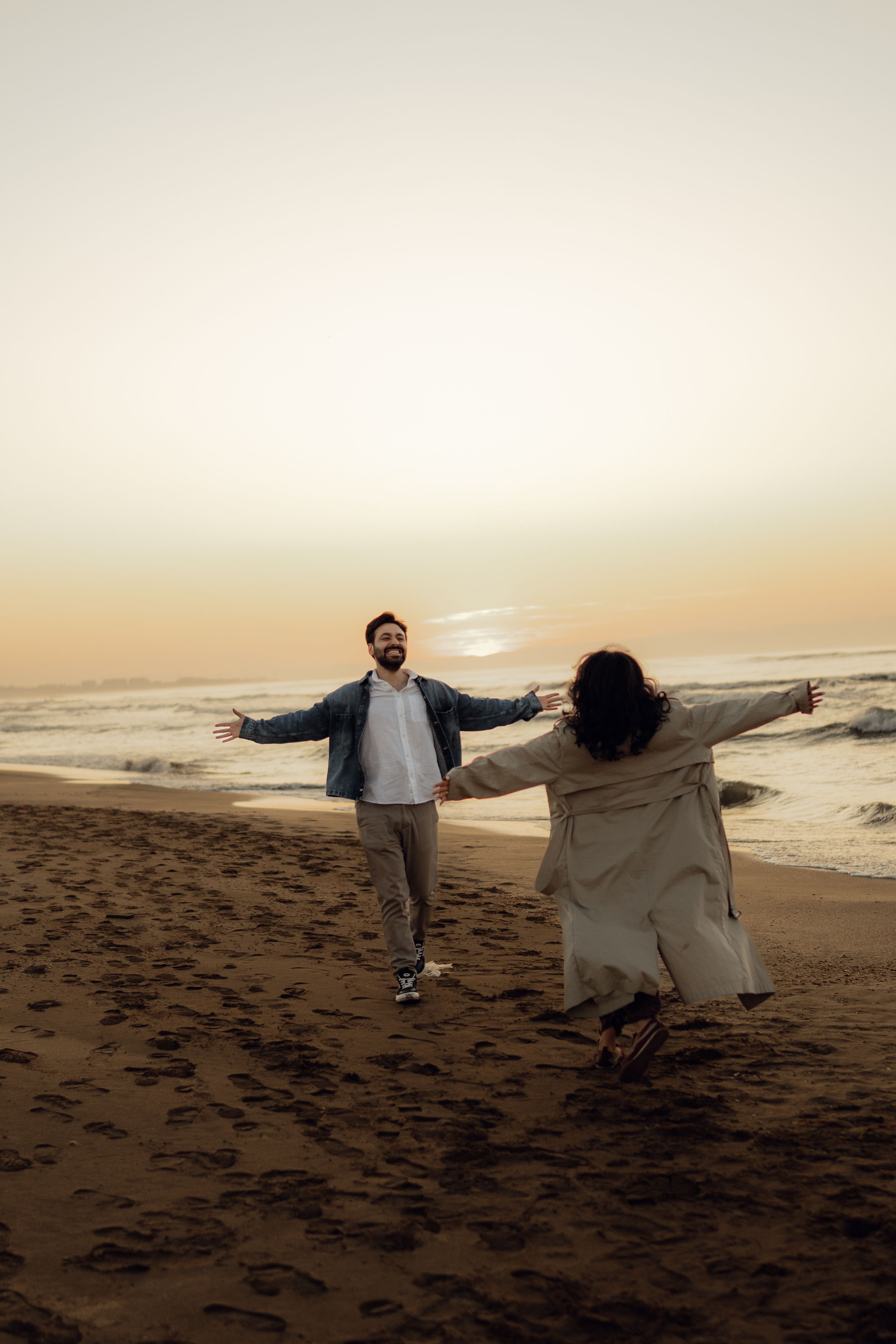 Happy Couple Embracing on a Beach at Sunset · Free Stock Photo