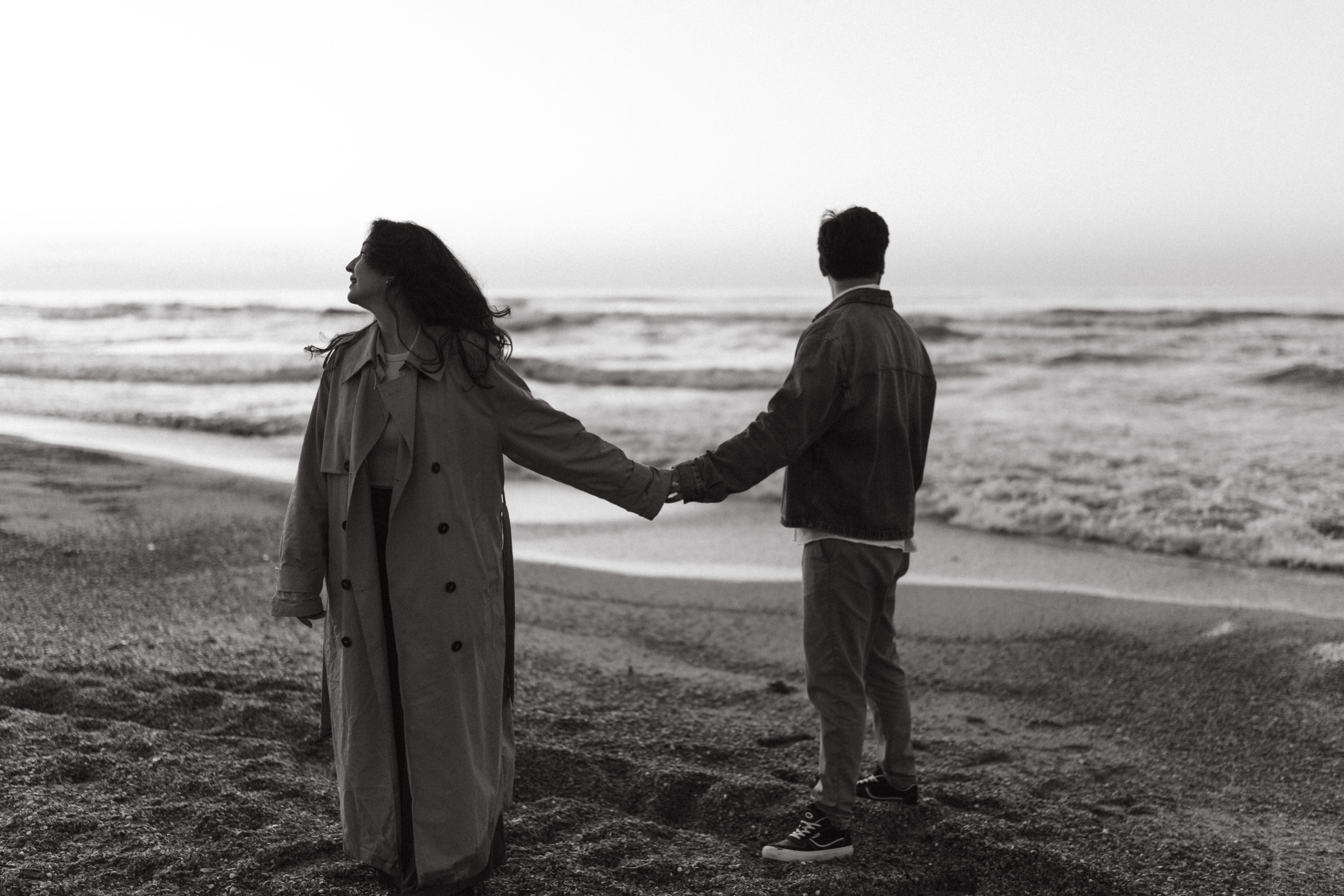 Black and White Beach Couple Holding Hands · Free Stock Photo