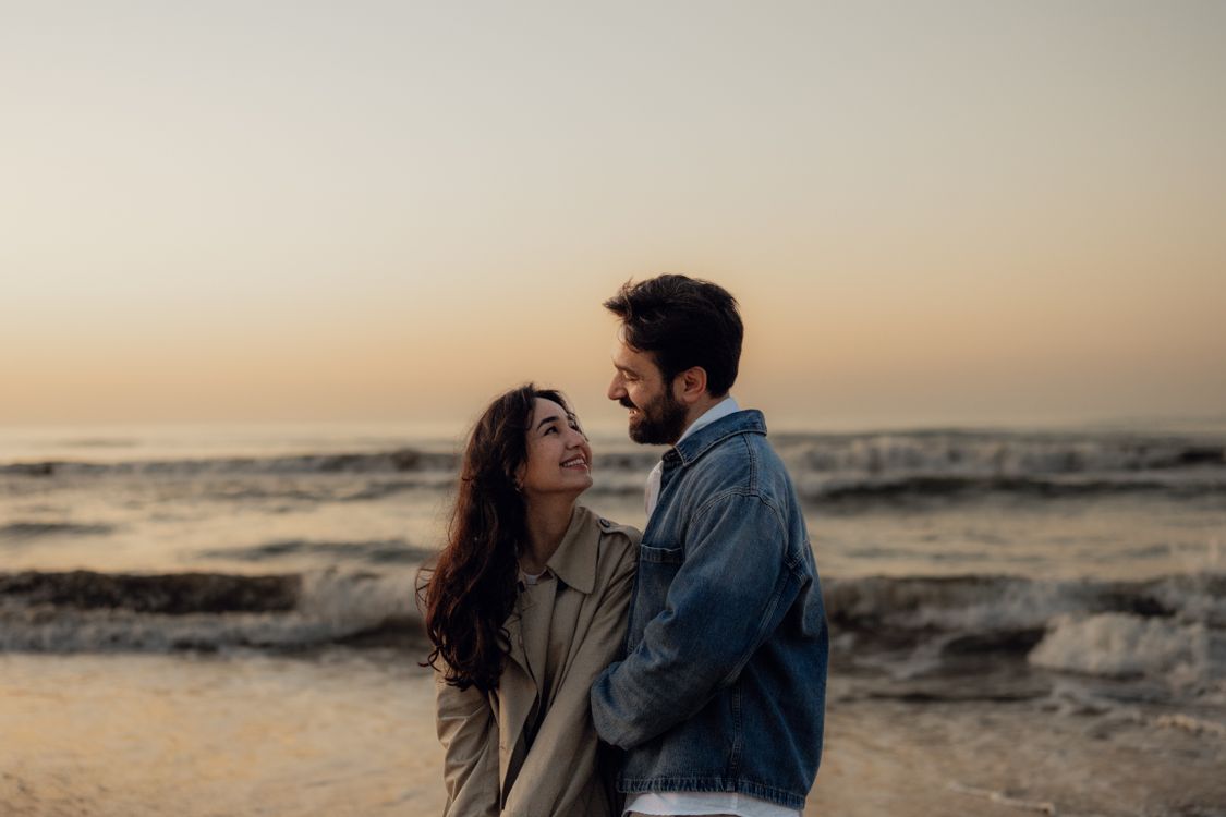 Romantic Couple Embracing at Sunset Beach · Free Stock Photo