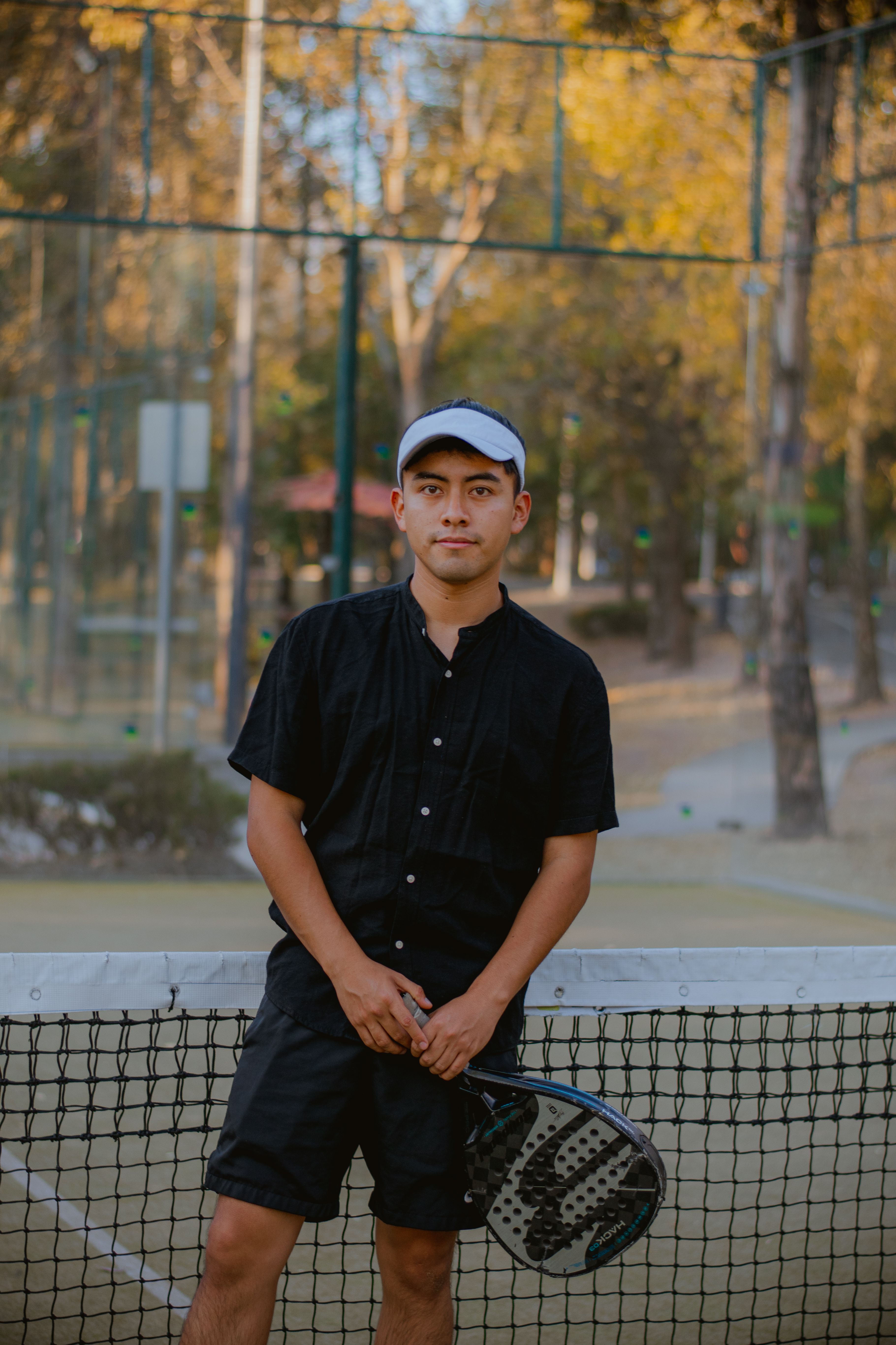 Young Man Posing with Racket Outdoors · Free Stock Photo
