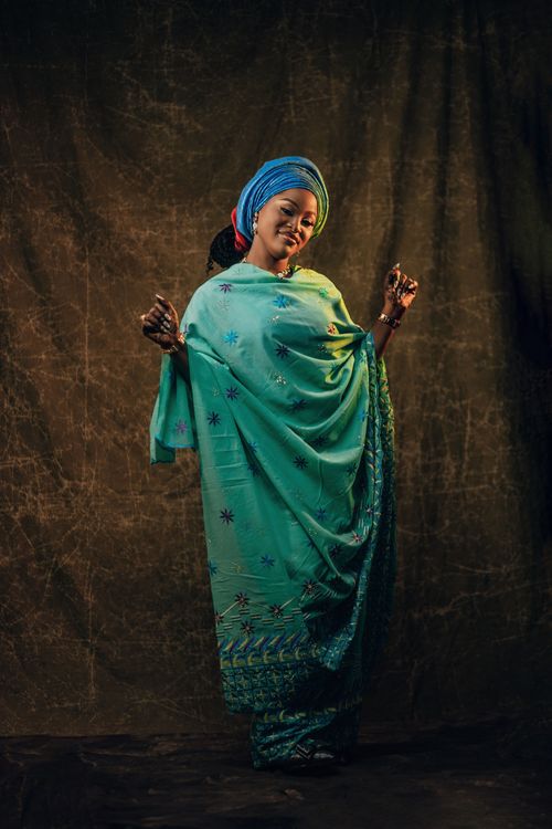Free Portrait of a woman wearing vibrant traditional African dress with a serene expression. Stock Photo