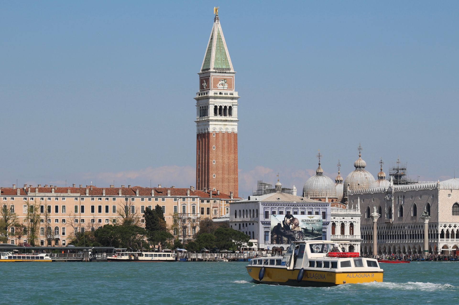 Scenic view of Venice's St Mark's Campanile with a water taxi in the canal.