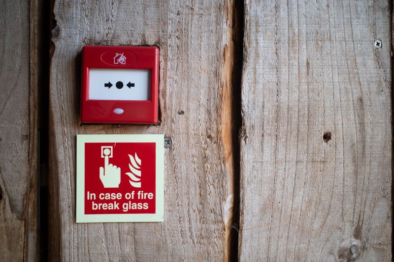 Wireless fire alarm device mounted on a period property wall