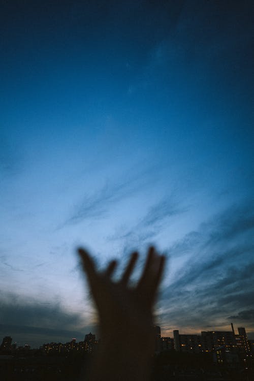 Free Persons Hand on White Clouds Stock Photo