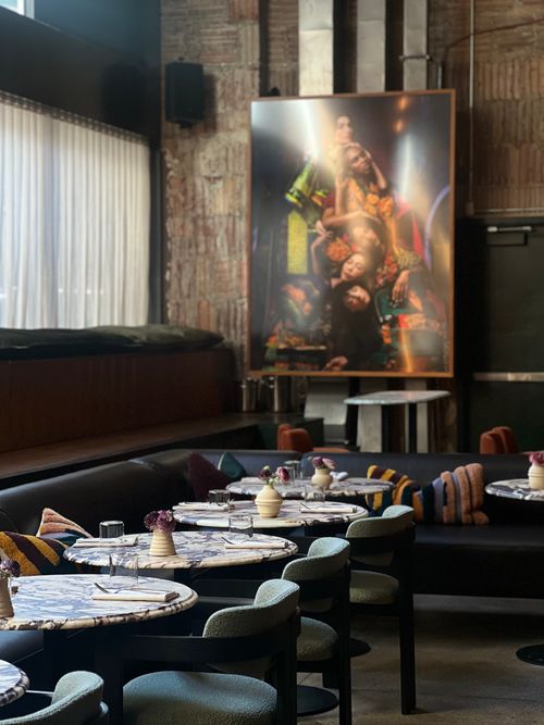 Free Chic restaurant interior with contemporary art and stylish table settings. Stock Photo