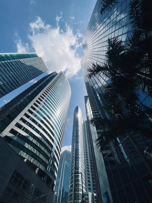 Free Dramatic low angle shot of towering skyscrapers against a blue sky with clouds. Stock Photo