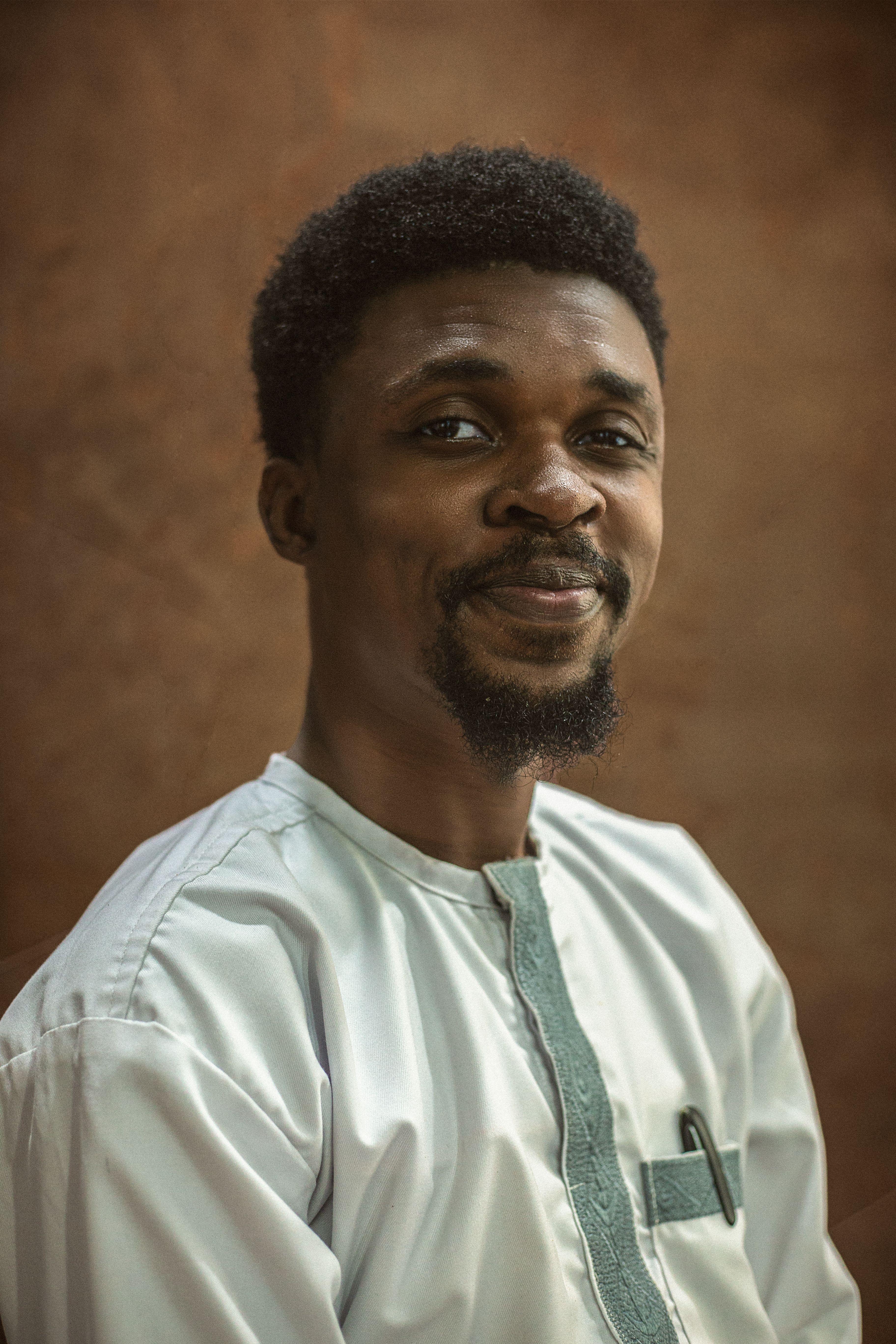 A portrait of a Nigerian man in traditional white attire, showcasing cultural elegance.
