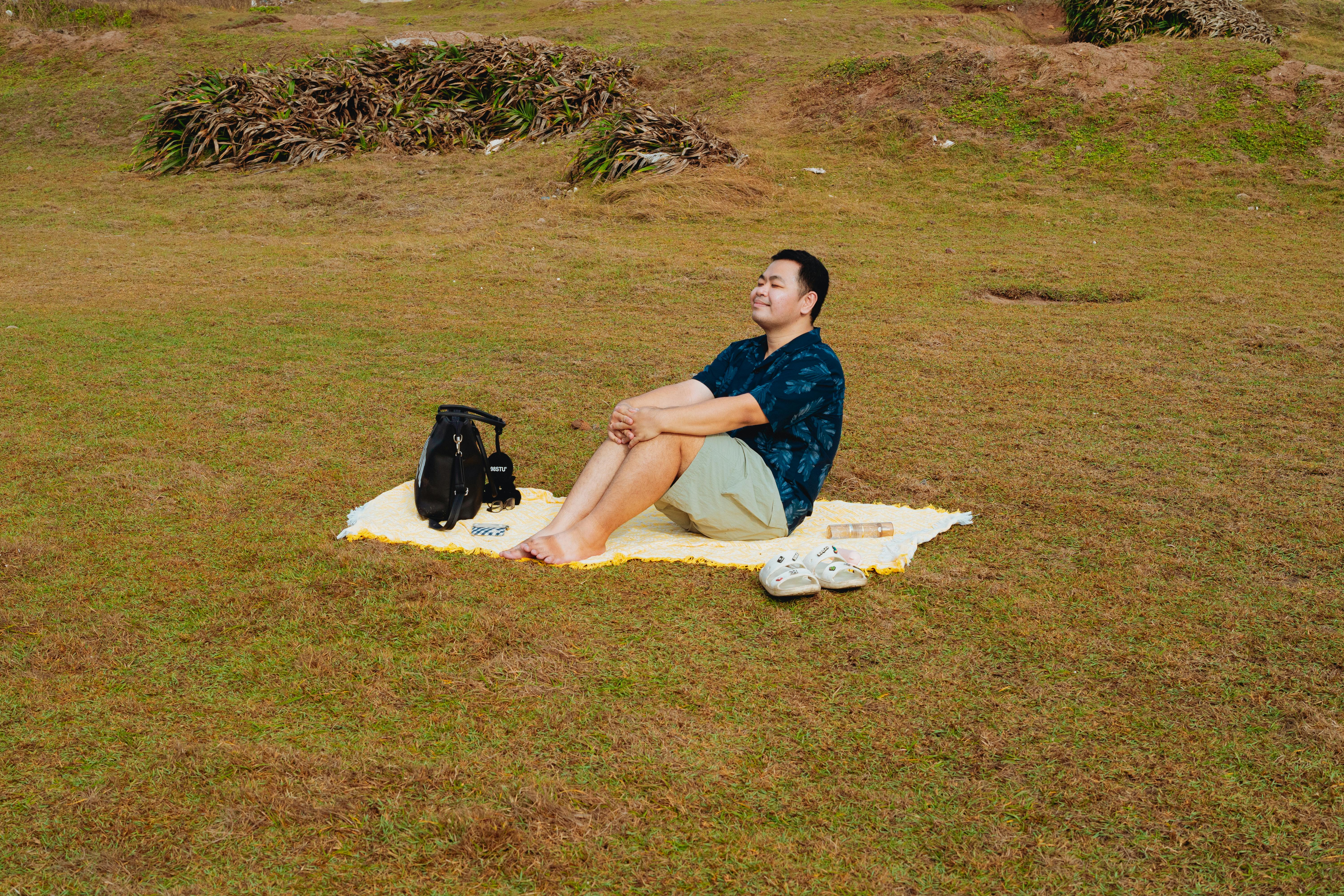 man relaxing on picnic blanket in binh thu n