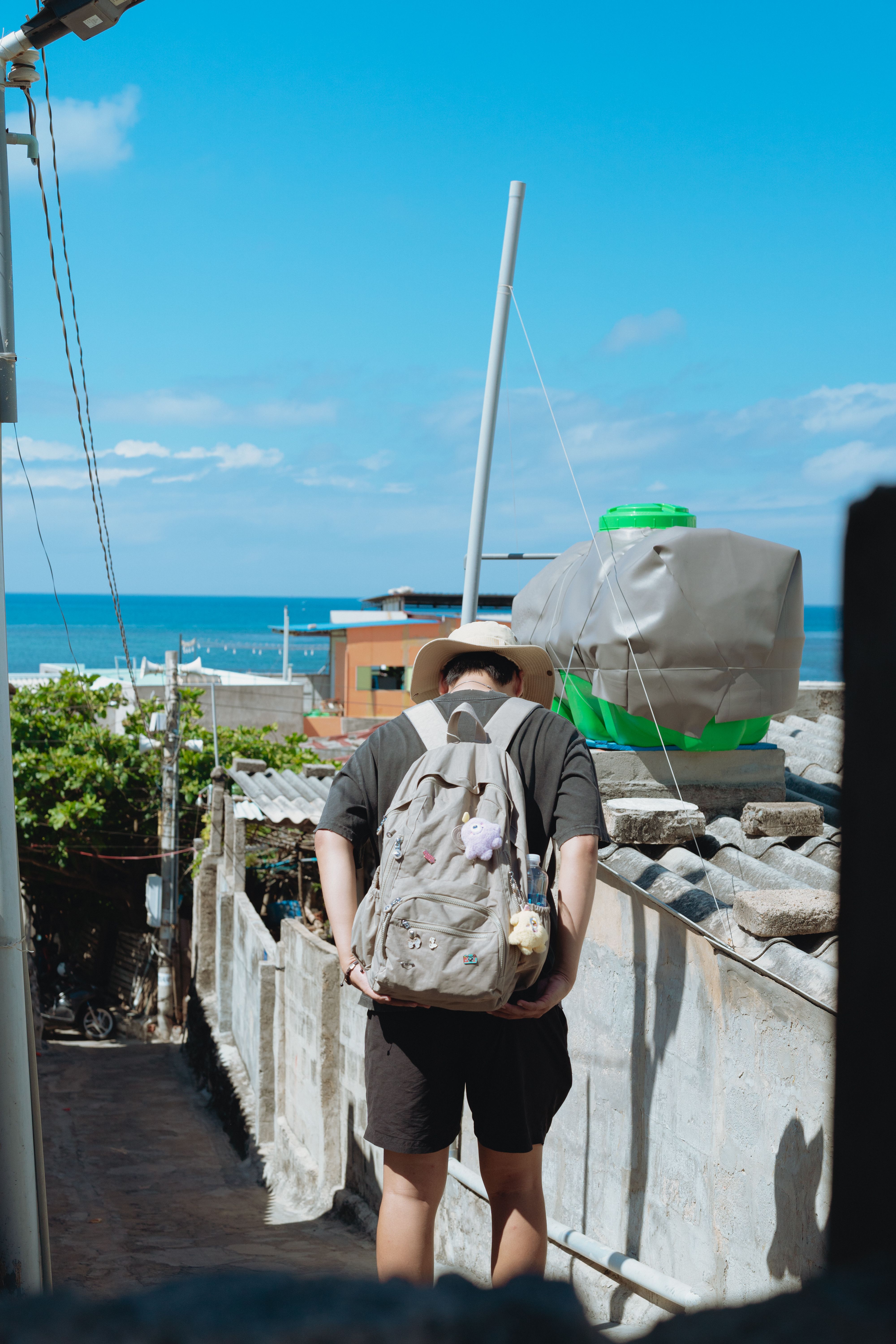 A traveler walks along a scenic path overlooking the ocean in Bình Thuận, Vietnam.
